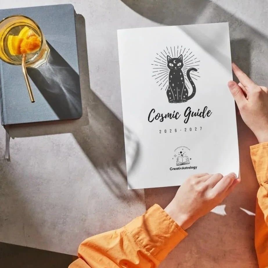 The Cosmic Guide 2026 to 2027, held open on a table